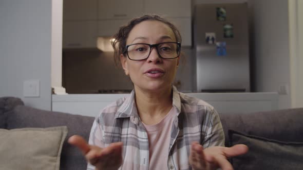 Adult Woman in Eyeglasses Holding Business Meeting Video Call at Home