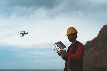 Male engineer doing inspection using drone - Technology and industrial concept