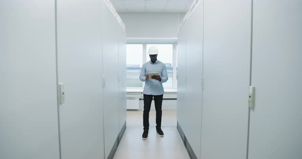 Portrait of an Engineer in a Hard Hat Holding a Tablet