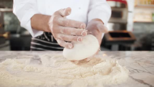 Italian Chef Making Dough for Pizza Traditional Food Man Working in Restaurant Kitchen High Cuisine