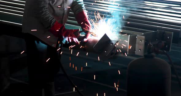 Industrial welder welding metal profiles