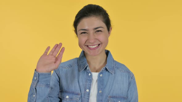 Indian Woman Waving, Yellow Background 