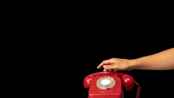 Hand Holding the Receiver of a Retro Red Telephone
