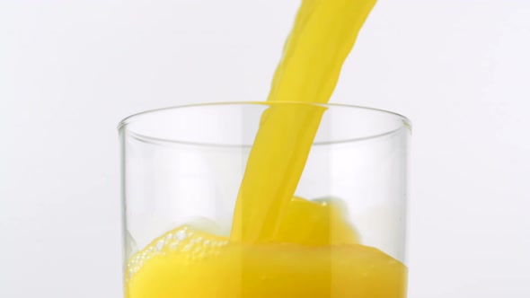 Pouring orange juice into glass, Slow Motion