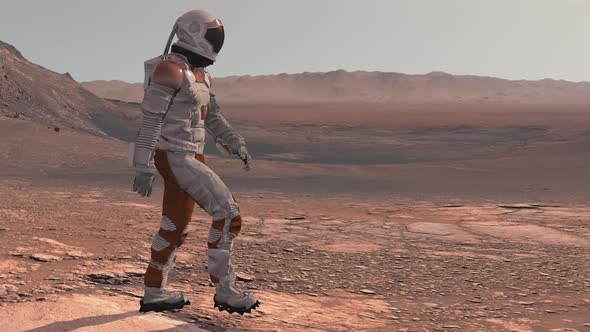 Astronaut Wearing Space Suit Walking On The Surface Of Mars