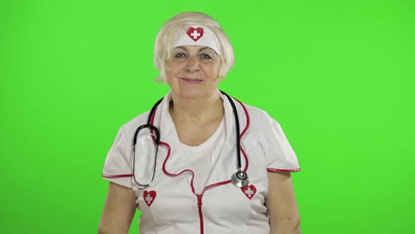 Elderly Caucasian Female Doctor. Female Nurse. Show OK Sign. Thumbs Up