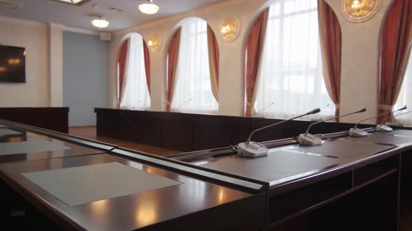 Camera Shows Conference Table Against Large Windows