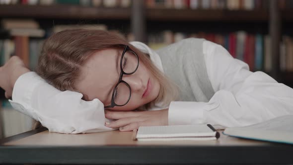 Schoolgirl with Glasses Learns Lessons Cute Girl Sleeping in Library While Doing Homework