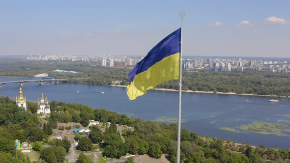 Aerial View of The Largest Flag of Ukraine is Flying Against the Backdrop of the City of Kyiv and