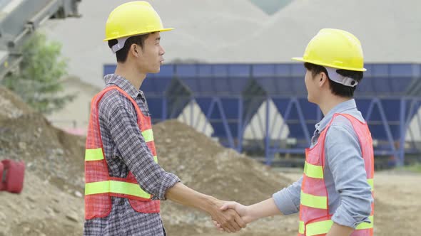 Construction Workers Shaking Hands And Talking alt