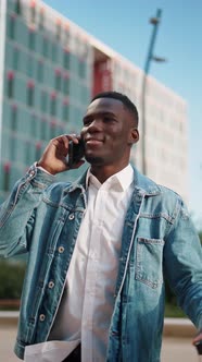 Black Man Speaking on Smartphone in City