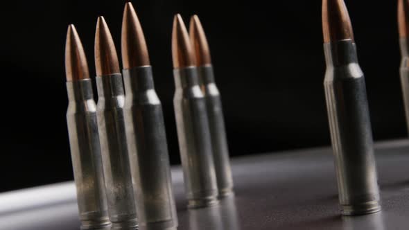 Cinematic rotating shot of bullets on a metallic surface - BULLETS 016