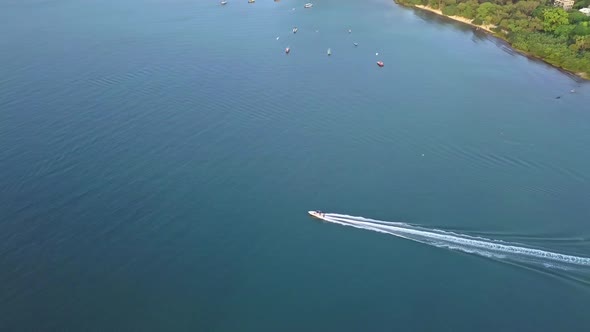 A dynamic tracking footage of a fast boat coming from a jetty in Ma On Shan town, Hong Kong. The spe