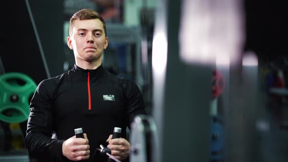 Fit Man Working Out with Gym Equipment