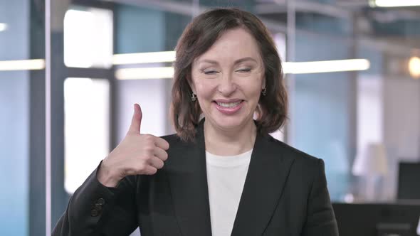 Portrait of Cheerful Middle Aged Businesswoman Showing Thumbs Up