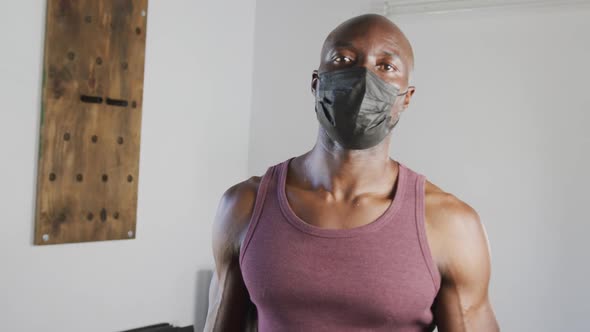 Portrait of fit african american man wearing face mask looking at camera