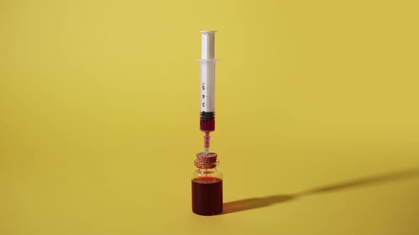 Syringe Draws Blood From a Glass Vial