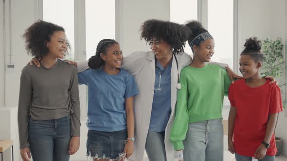 African American doctor and kids making laughing in the hospital or clinic.