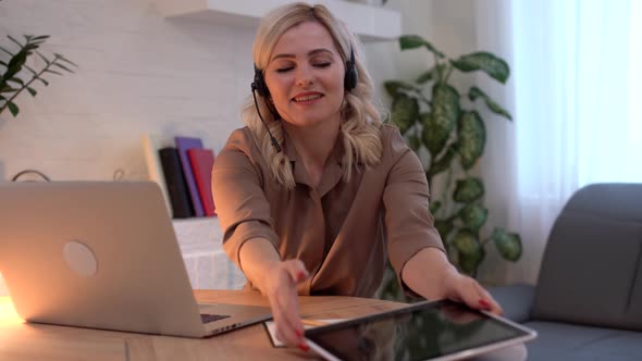 Woman Having Video Chat with Colleagues at Laptop in Office Closeup