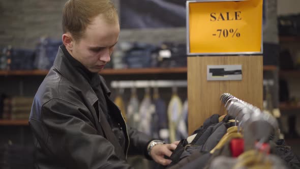 Young Caucasian Man Having Heart Attack While Choosing Clothes in Shopping Mall. Portrait of Ill