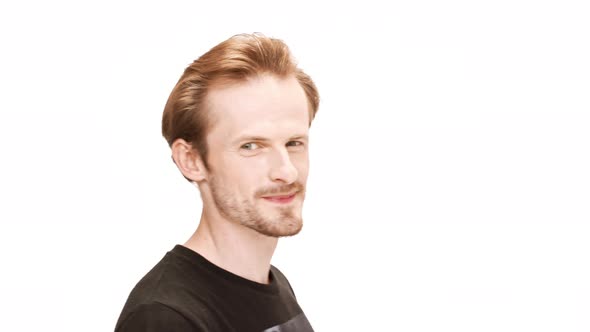 Playful Young Handsome Man Smiling Over White Background