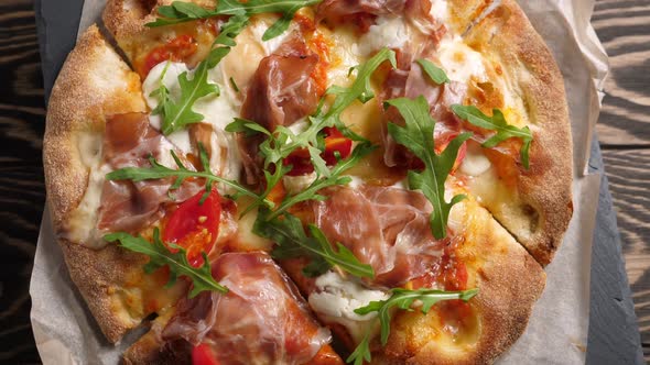 Prosciutto Pizza with Strachatella Cheese Tomatoes and Arugula Leaves