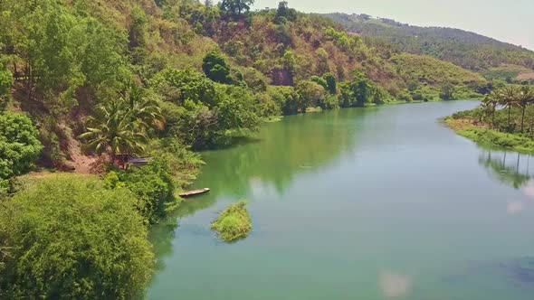 Flycam Shows Green River Against Dense Jungle in Vietnam