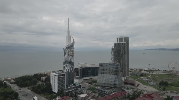 Aerial shot of alphabetic tower, skyscrapers and embankment of beautiful city of Batumi, Georgia