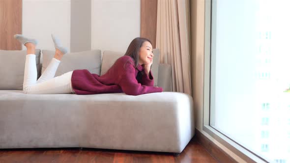 Asian woman sit on sofa and relax