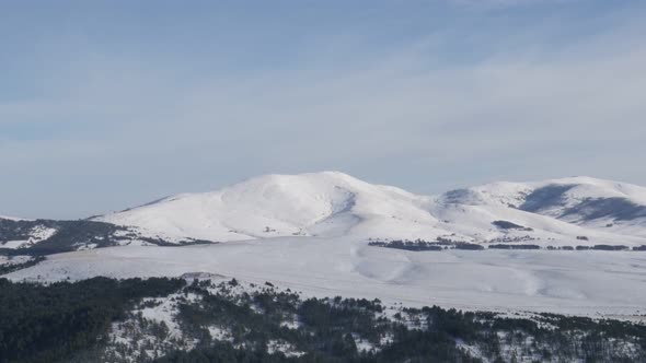 Famous ski resort of Zlatibor with snowed hills on horizon slow tilt 4K 2160p 30fps UltraHD footage 