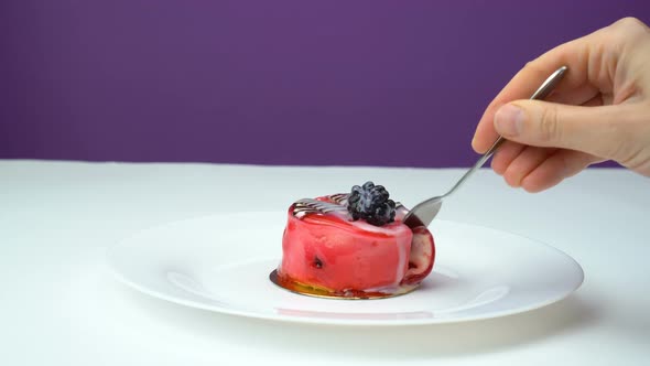 Close Up Spoon and Fruit Cupcake with White Whipped Cream and Slices of Fresh Red and Blackberry