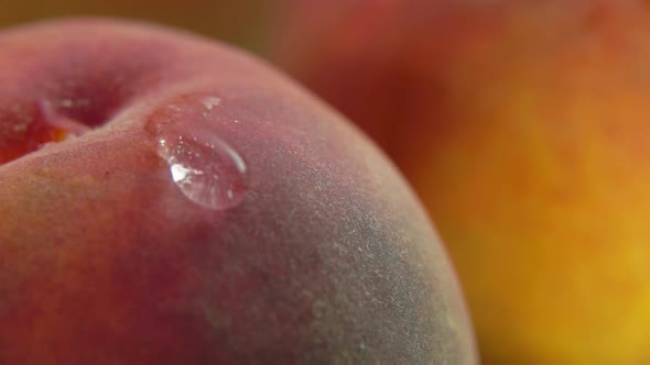 Shining Drop of Water Flows Down the Peach