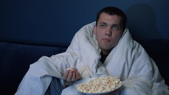 Portrait Bored Caucasian Man Sitting Sofa Home Blanket Throwing Popcorn Catching It His Mouth Self