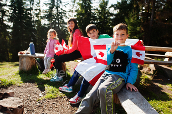  hold large Canadian flag celebration in mountains.