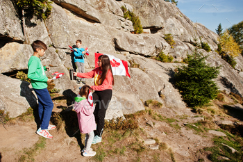  hold large Canadian flag celebration in mountains.