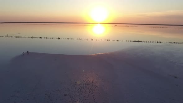 Aerial Short  of Surface Covered with White Sand at Black Sea Coast at Sunset 