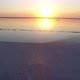 Aerial Short  of Surface Covered with White Sand at Black Sea Coast at Sunset  - VideoHive Item for Sale