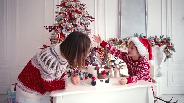 Mother and Son are Sitting Near the Christmas Cake