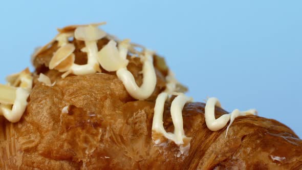 Сroissant dessert on a blue background. Close-up, the camera slowly moves along the slider.