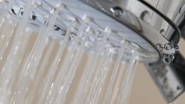 Close Up of Water Drops Flowing From Shower Head in Bathroom Slow Motion