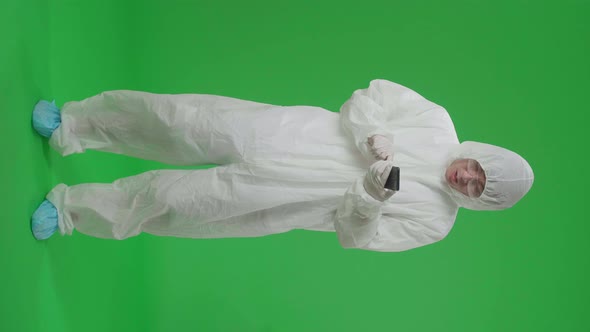 Full Body Of Man Wear Protective Uniform Ppe Use Mobile Phone And Say Wow In The Green Screen Studio