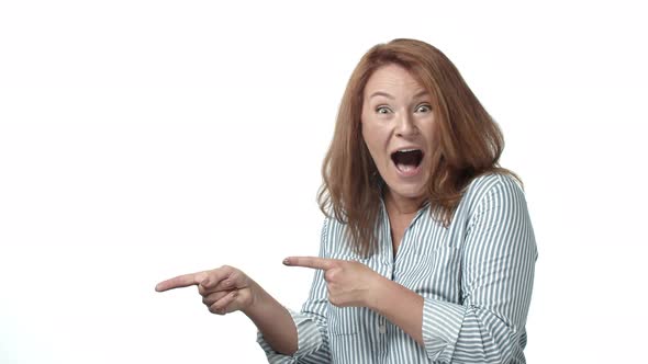 Ecstatic Cheerful and Excited Redhead Adult Woman Cheering Pointing Empty Space Left and Joyfully