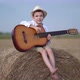 Little Boy on a Haystack with a Guitar - VideoHive Item for Sale
