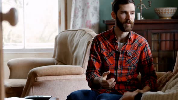 Couple arguing each other in living room