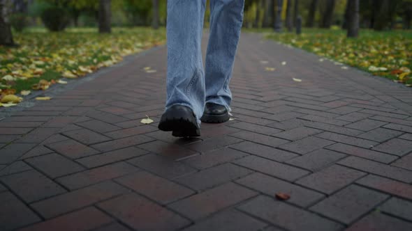 Close Up Unknown Female Walking in Boots and Jeans in Autumn Park