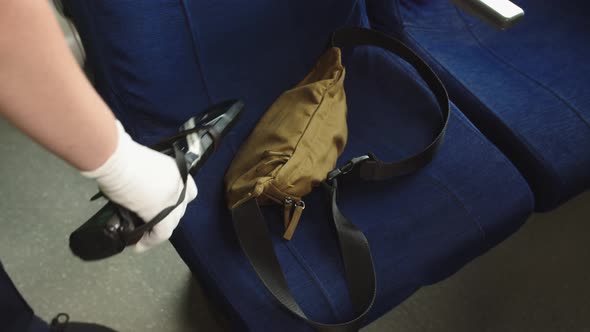 A Special Security Service on Railway Transport Checks a Bag Forgotten By a Passenger Using a Metal