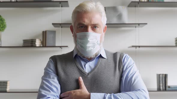 Close Up Portrait of Elderly Man in Medical Face Mask.