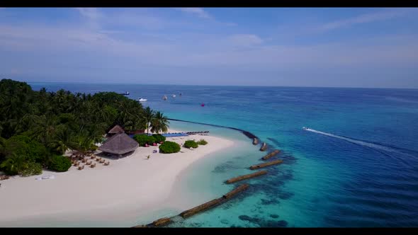 Aerial drone view scenery of beautiful shore beach holiday by blue green sea with white sandy backgr