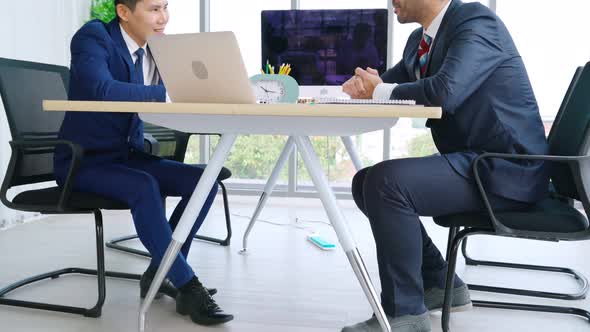 Two Business People Talk Project Strategy at Office