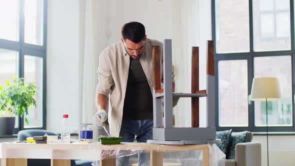 Man Painting Old Wooden Table in Grey Color